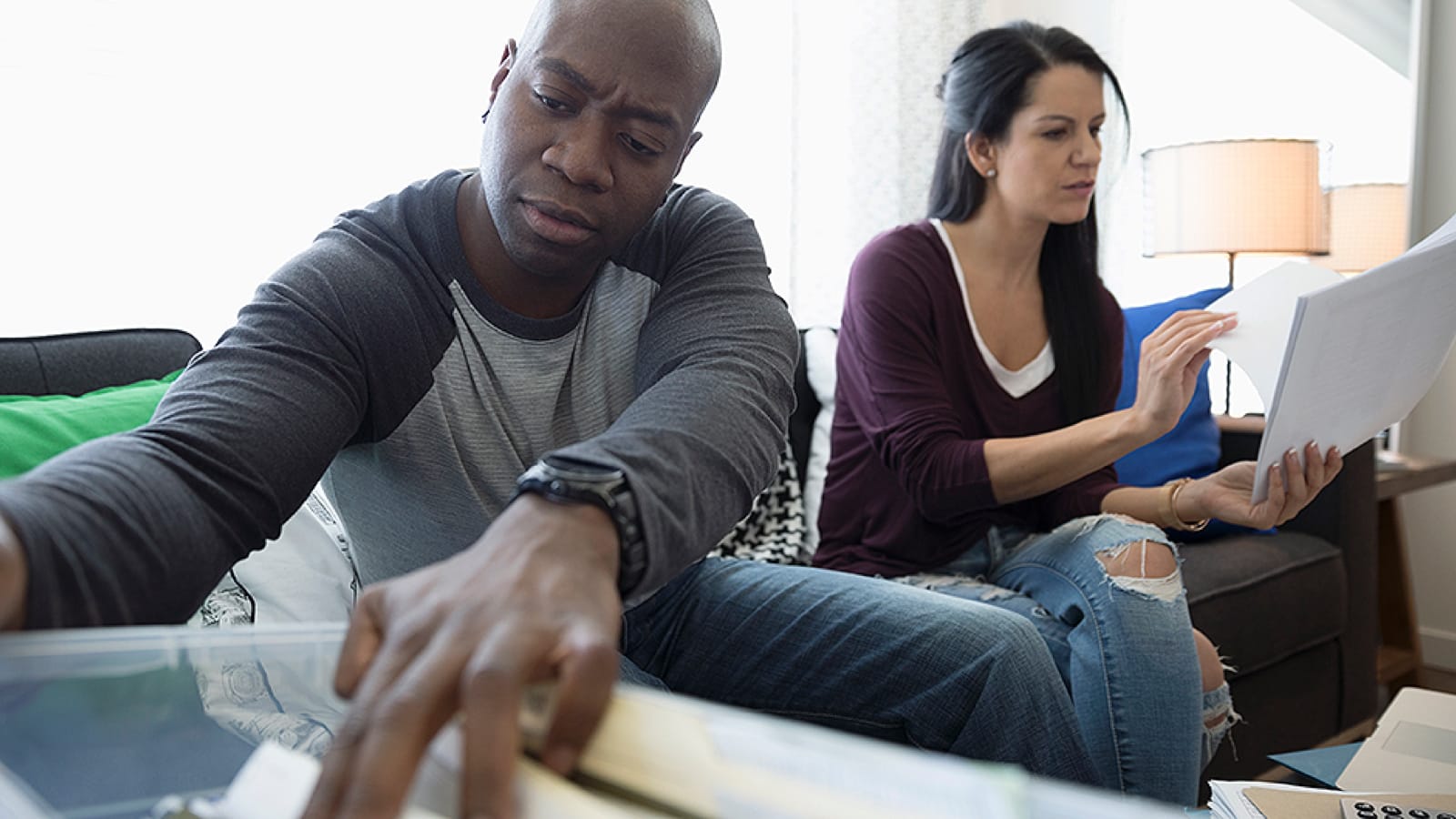 lostpolicy_large Couple looking through paperwork to find a lost life insurance policy