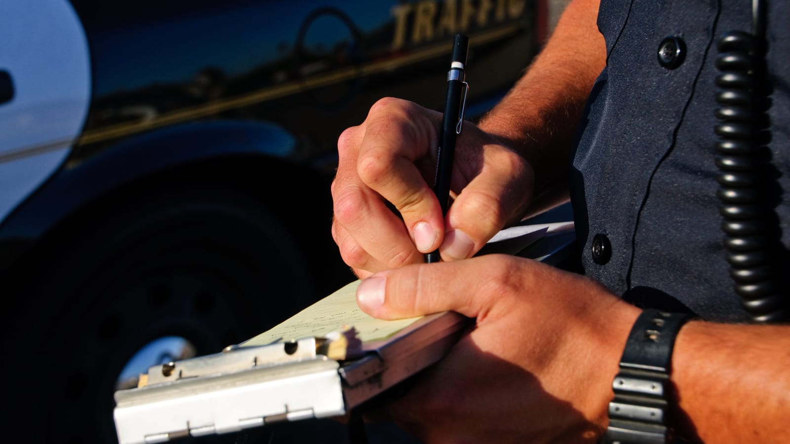 Traffic Ticket Cop writing a traffic ticket